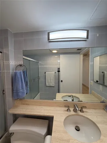 a bathroom with a toilet sink and shower
