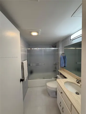 a kitchen with refrigerator and window