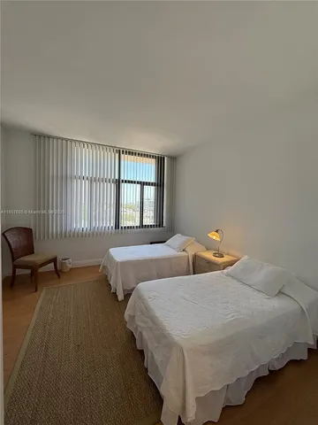 a bedroom with two beds and painted walls