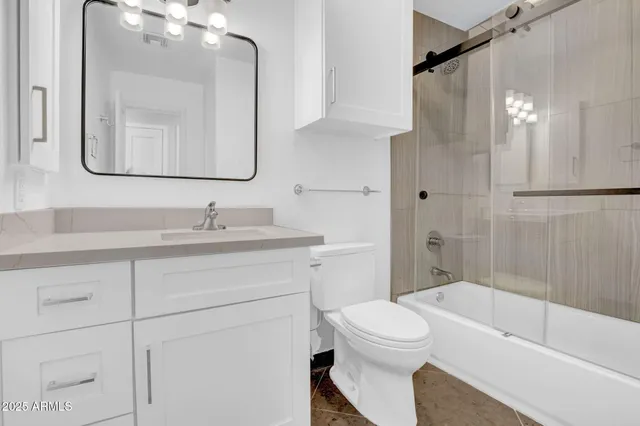 a bathroom with a toilet a sink a tub and mirror