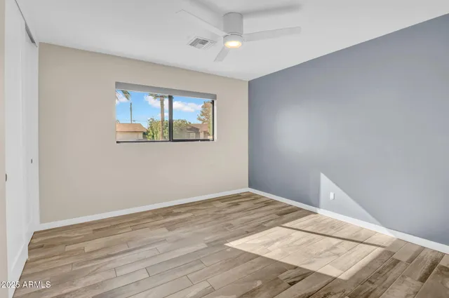 a view of empty room with wooden floor