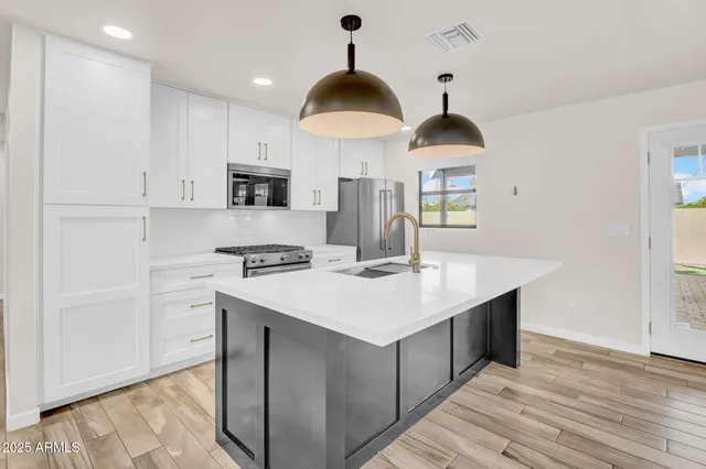 a kitchen with a sink a counter top space and cabinets