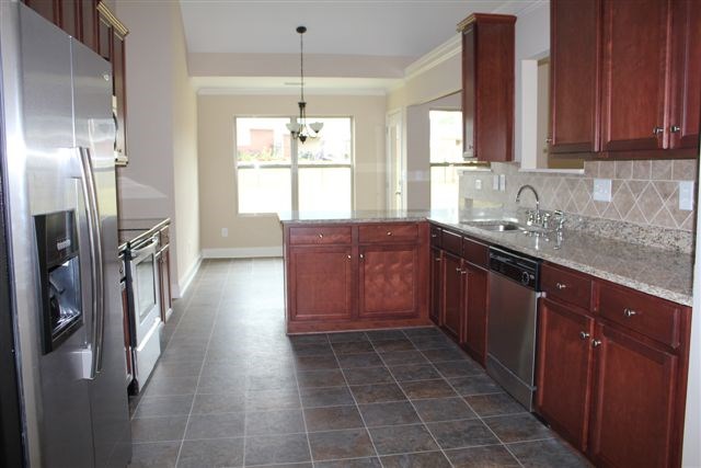 2141 Lee Road Phenix City, AL 36870 - Photo 11 of 24 a kitchen with stainless steel appliances granite countertop a sink stove and refrigerator