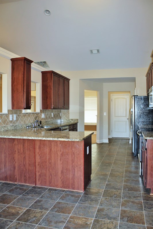 2141 Lee Road Phenix City, AL 36870 - Photo 13 of 24 a kitchen with granite countertop a sink and cabinets
