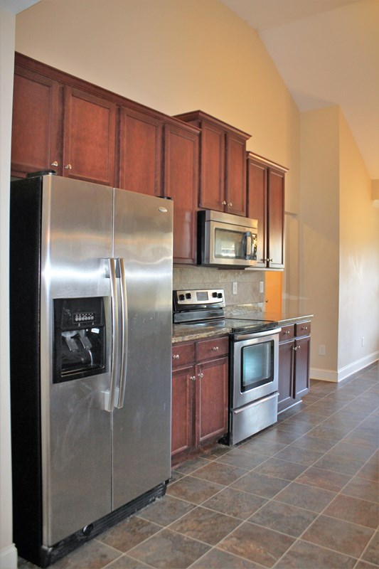 2141 Lee Road Phenix City, AL 36870 - Photo 15 of 24 a kitchen with stainless steel appliances granite countertop a refrigerator a stove a sink and dishwasher