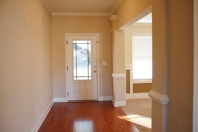 2141 Lee Road Phenix City, AL 36870 - Photo 3 of 24 an empty room with wooden floor and windows