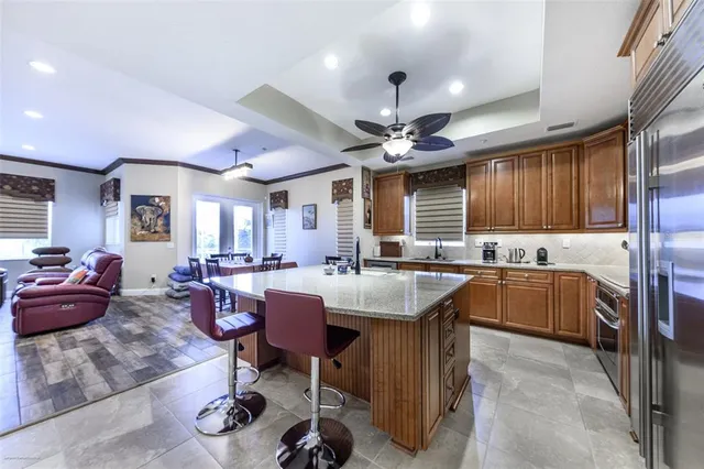 a living room with lots of furniture and kitchen view