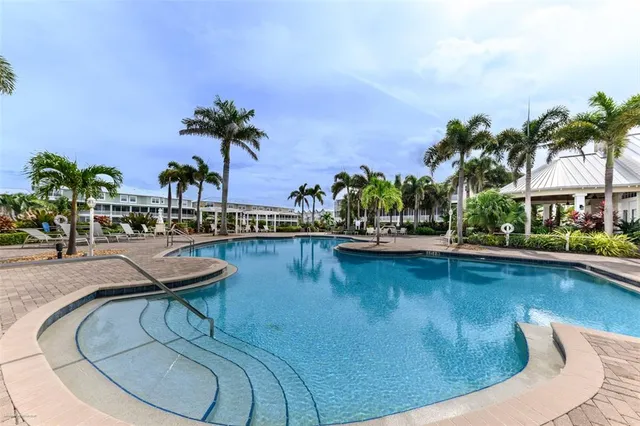 a view of swimming pool with outdoor seating and plants