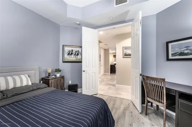 a bedroom with bed and a chandelier