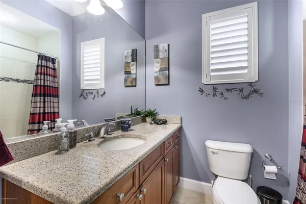 a spacious bathroom with a tub shower and window