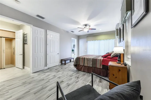 a bedroom with a bed and a chandelier
