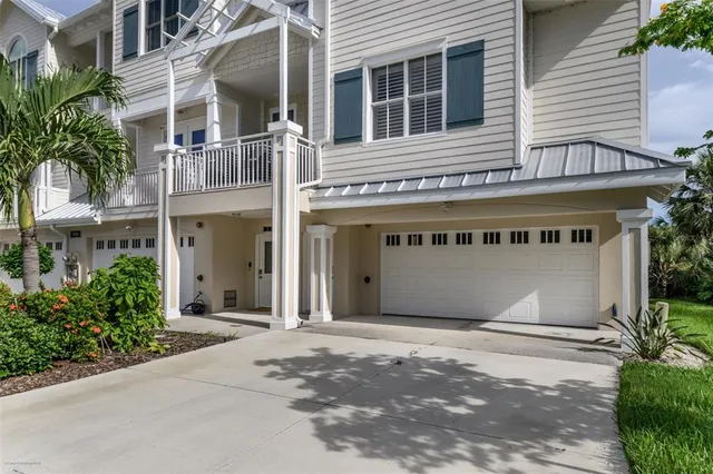 a kitchen with stainless steel appliances granite countertop a refrigerator a stove and a sink with wooden cabinets