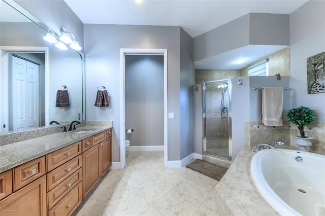 a front view of a building with a garden and plants