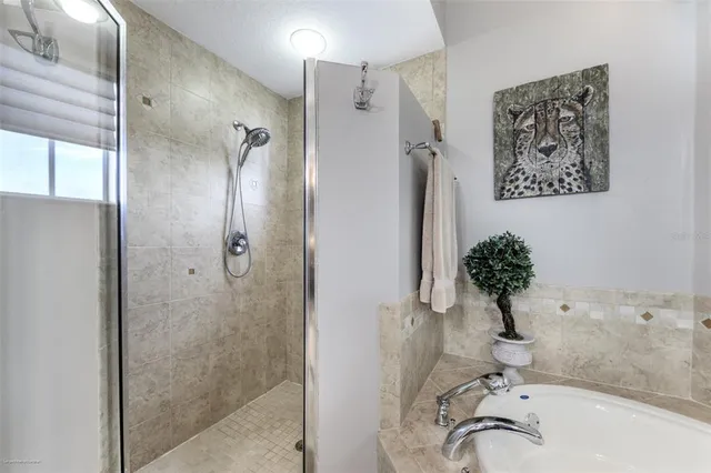 a view of a patio with table and chairs potted plants and floor to ceiling window with potted plants