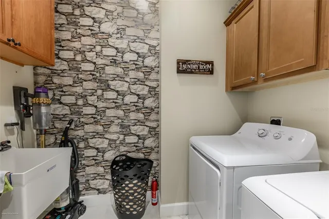 a view of a swimming pool with a patio and a yard