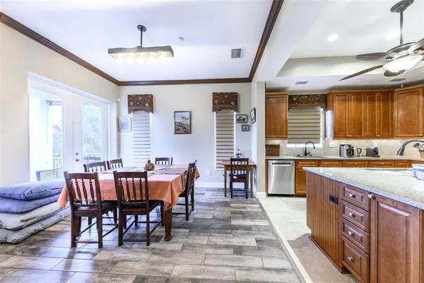 a kitchen with stainless steel appliances granite countertop a sink a stove and a wooden floors