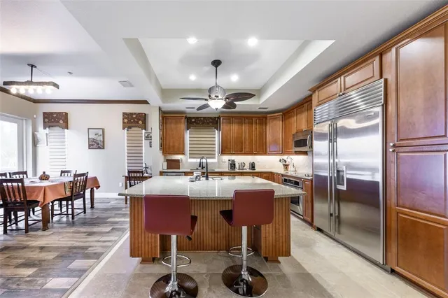 a kitchen with stainless steel appliances granite countertop a stove and a sink