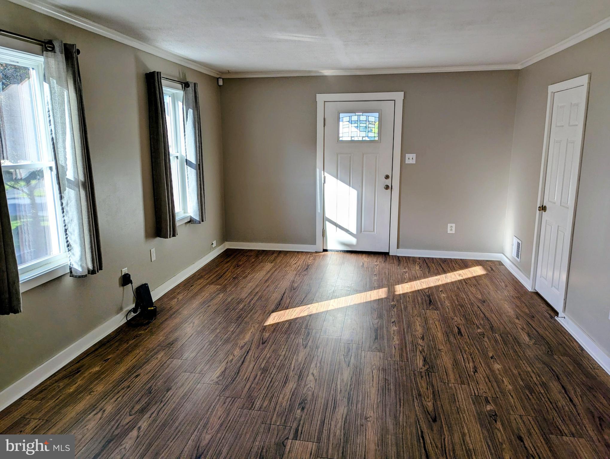 4917 Shepherd Street Brookhaven, PA 19015 - Photo 6 of 34 a view of an empty room with wooden floor and a window