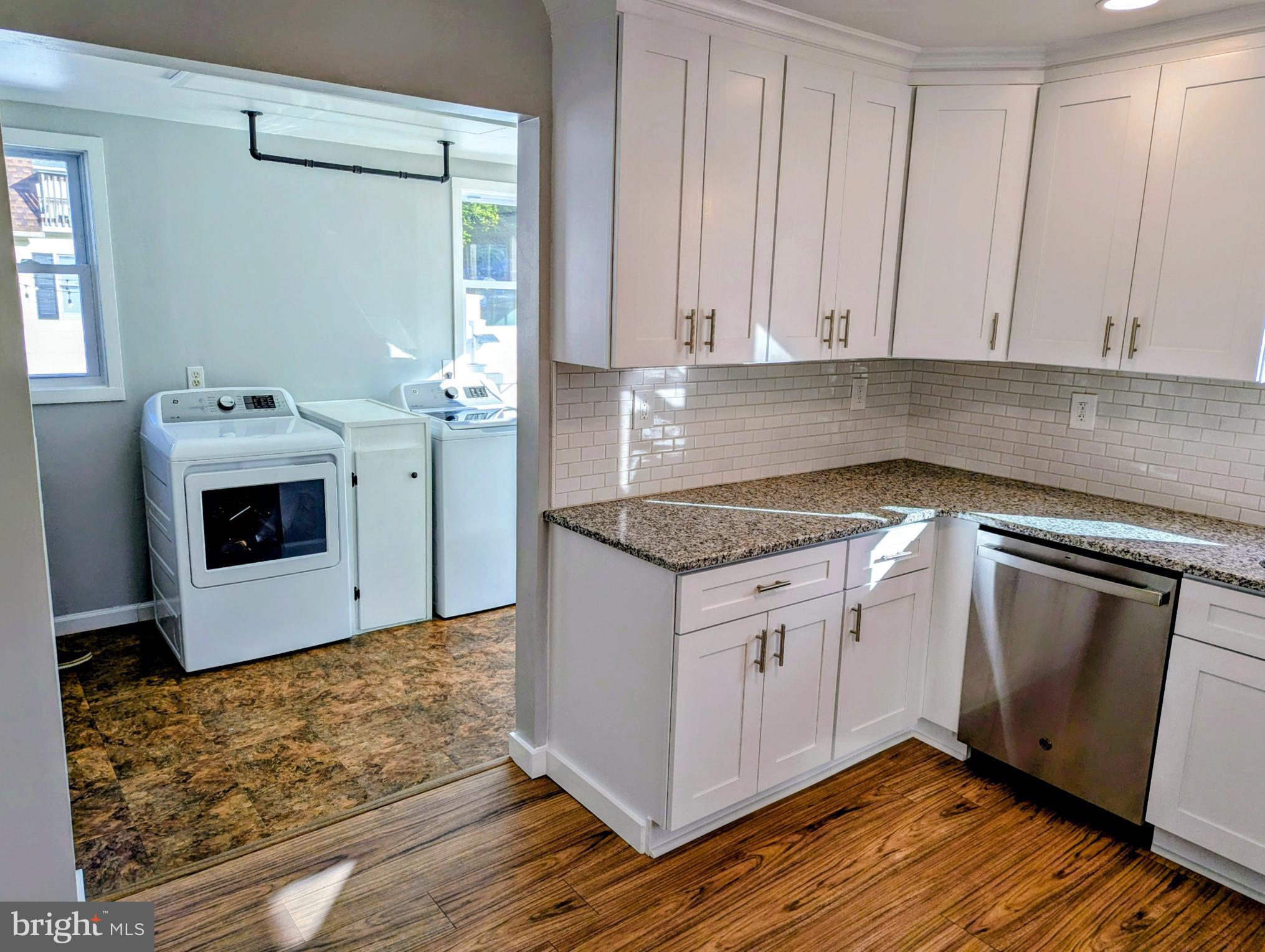 4917 Shepherd Street Brookhaven, PA 19015 - Photo 9 of 34 a kitchen with granite countertop white cabinets and white appliances