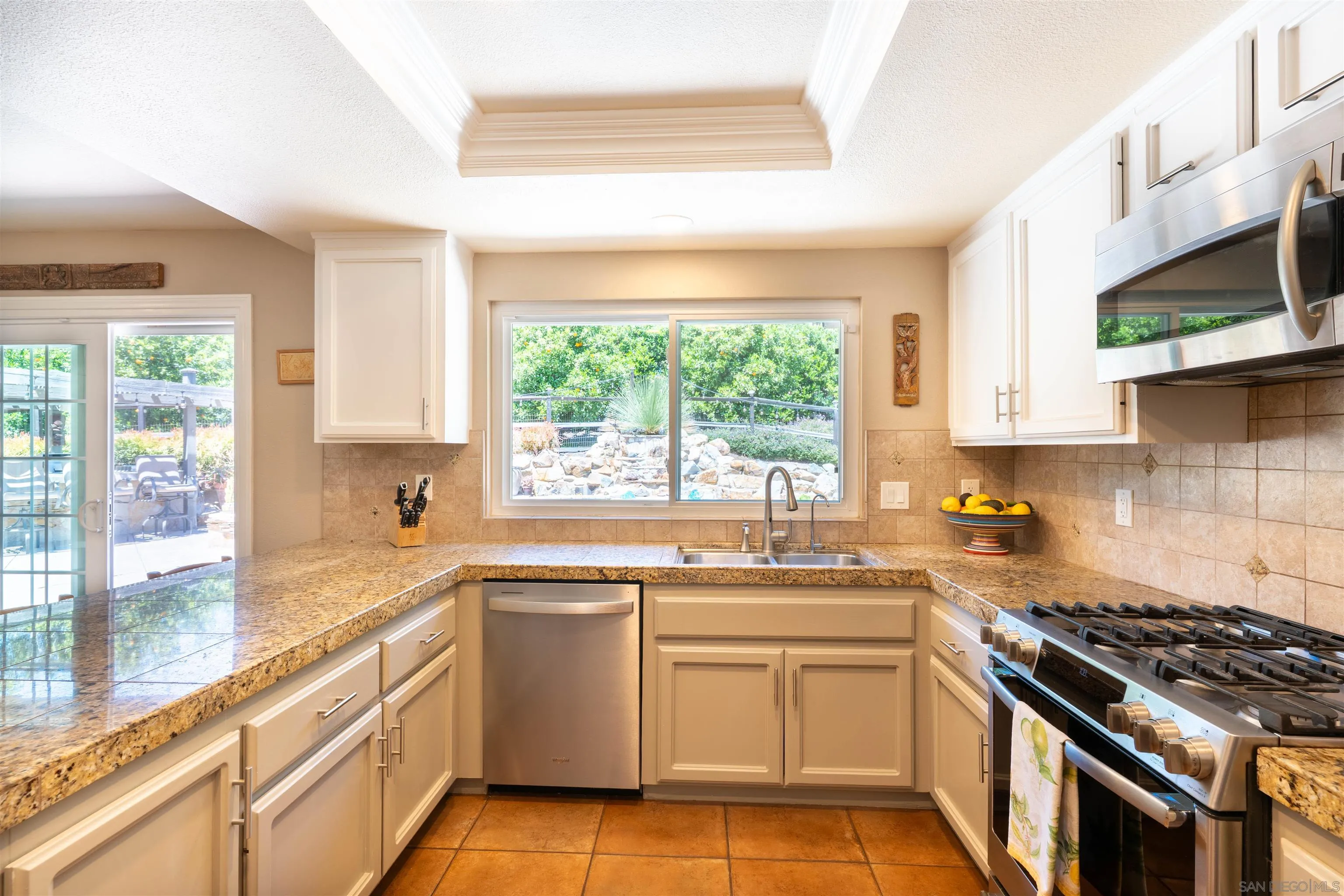 1045 Capra Way Fallbrook, CA 92028 - Photo 14 of 44 a kitchen with a sink stove top oven and cabinets