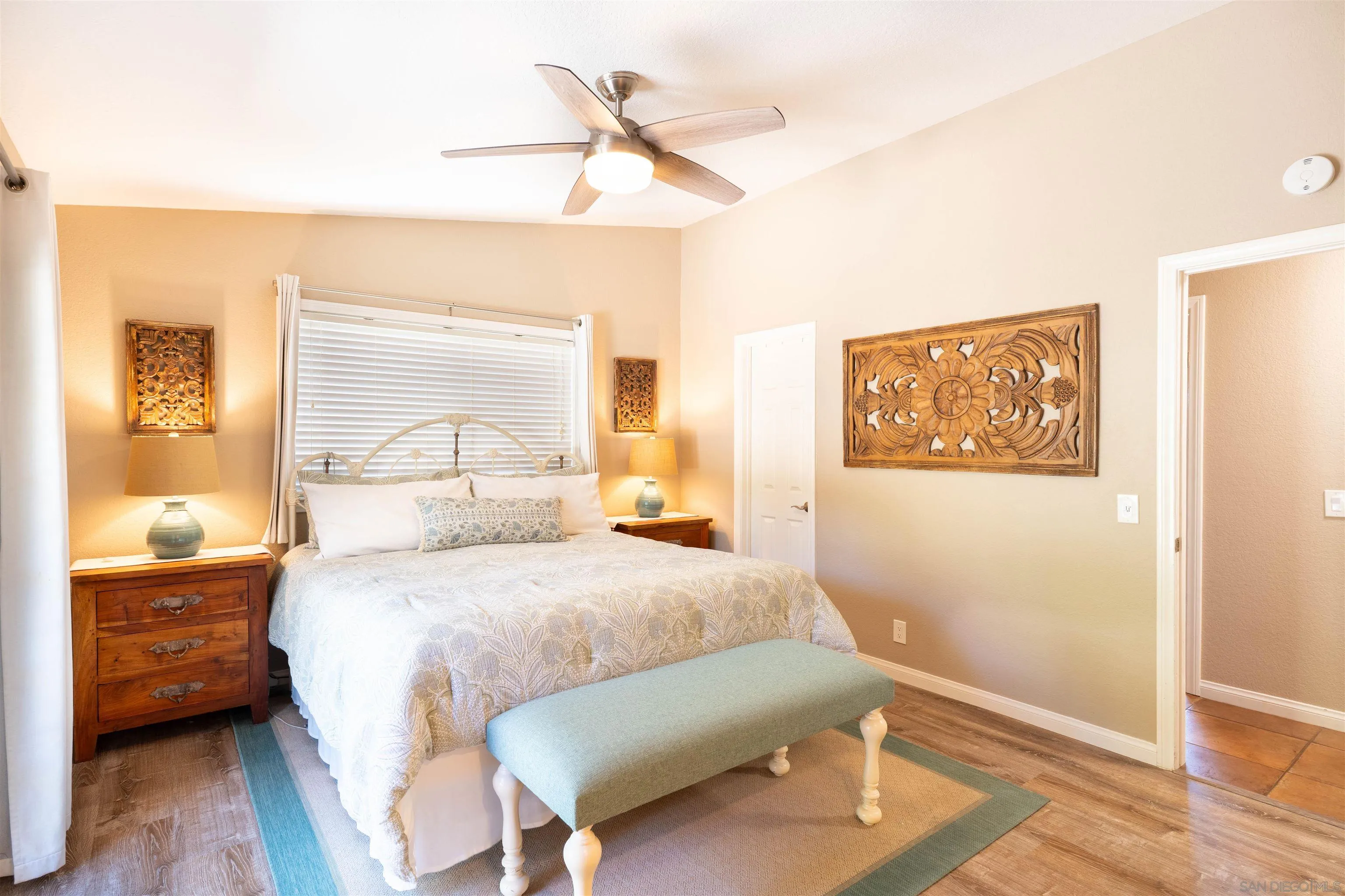 1045 Capra Way Fallbrook, CA 92028 - Photo 17 of 44 a bedroom with a bed and a painting on the wall