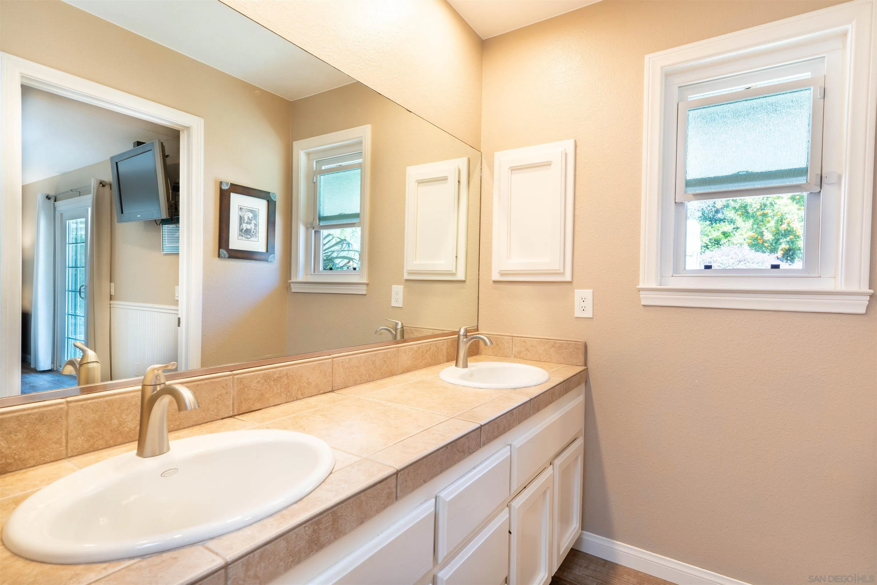 1045 Capra Way Fallbrook, CA 92028 - Photo 18 of 44 a bathroom with a sink and a mirror