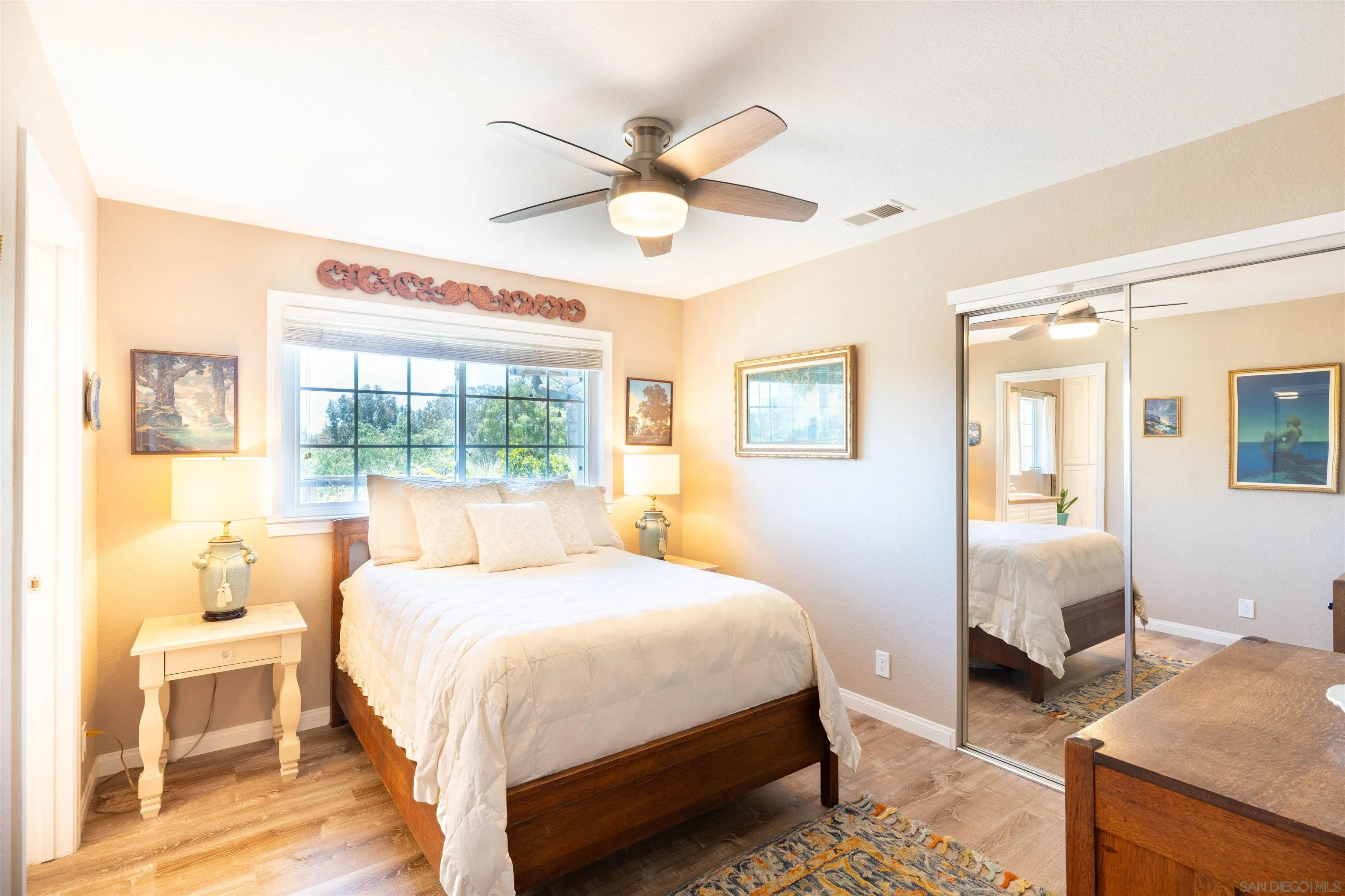 1045 Capra Way Fallbrook, CA 92028 - Photo 19 of 44 a bedroom with a bed and wooden floor