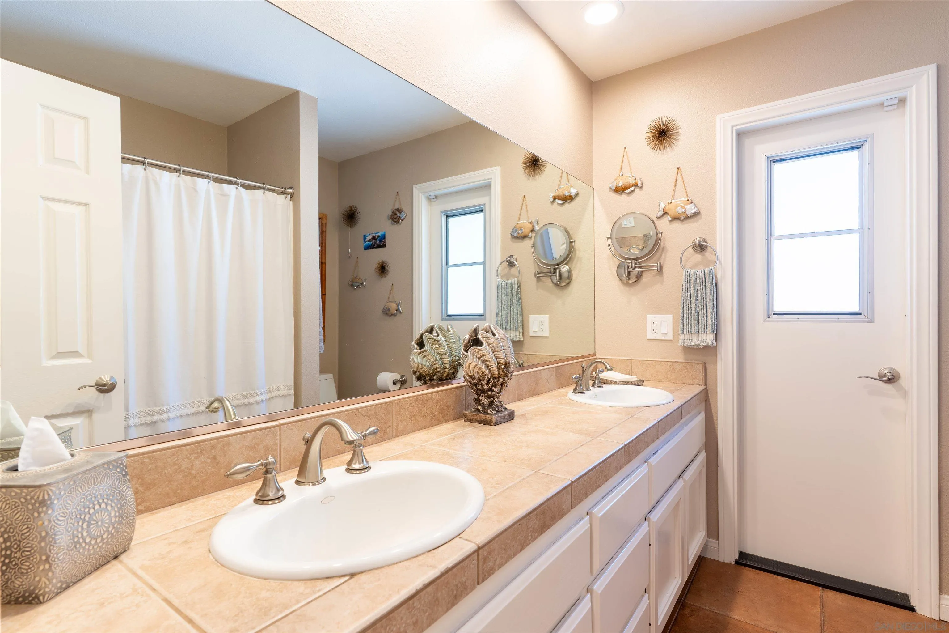 1045 Capra Way Fallbrook, CA 92028 - Photo 20 of 44 a bathroom with a sink and a mirror