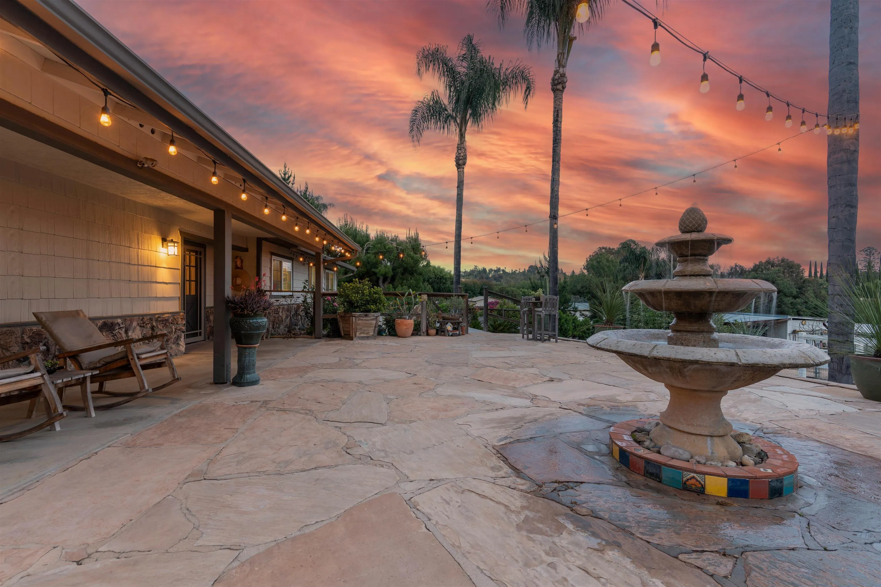 1045 Capra Way Fallbrook, CA 92028 - Photo 5 of 44 a view of a patio with table and chairs potted plants with wooden floor