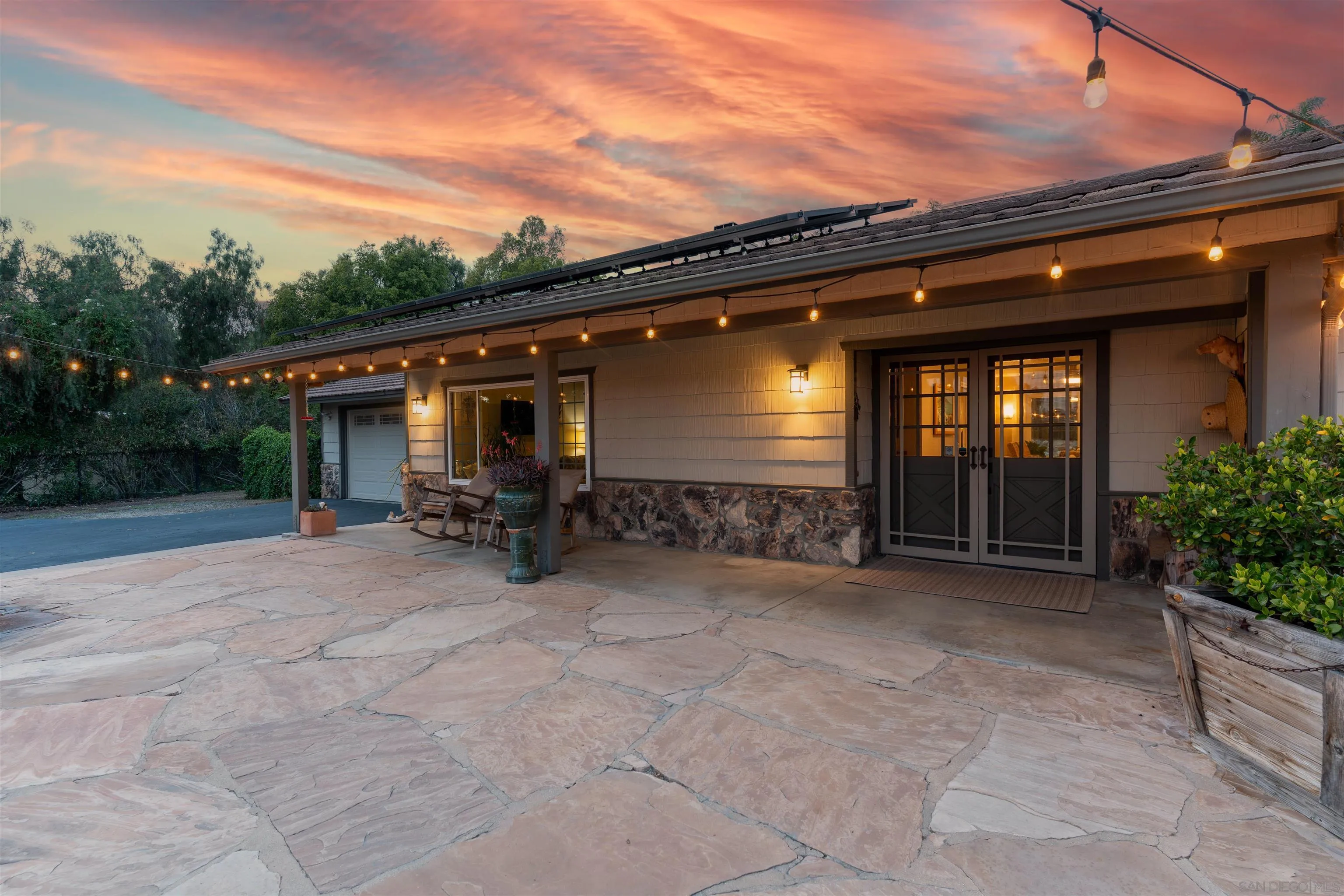 1045 Capra Way Fallbrook, CA 92028 - Photo 6 of 44 a view of a patio with table and chairs a flat tv screen and a floor to ceiling window