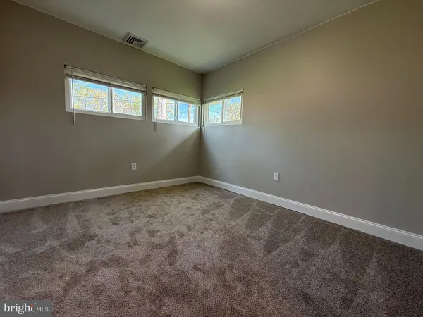 an empty room with a empty space and windows