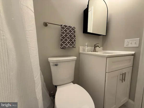 a white toilet sitting next to a bathroom sink