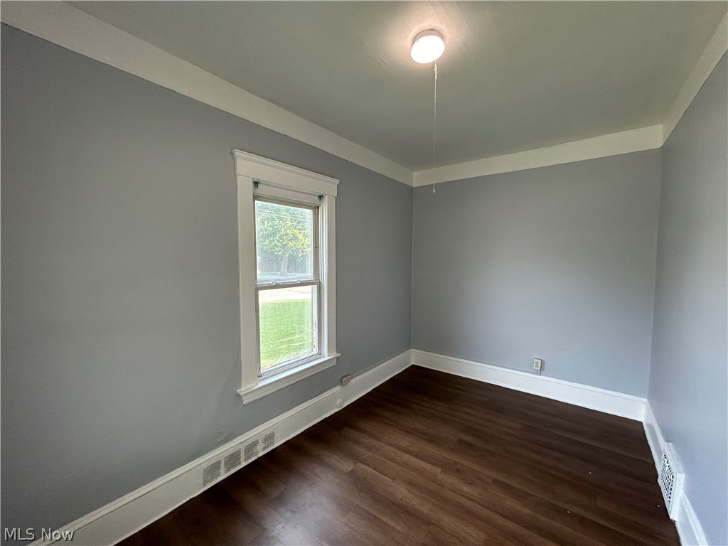 3403 Fulton Road, Unit DOWN Cleveland, OH 44109 - Photo 8 of 18 Unfurnished room with dark hardwood / wood-style floors