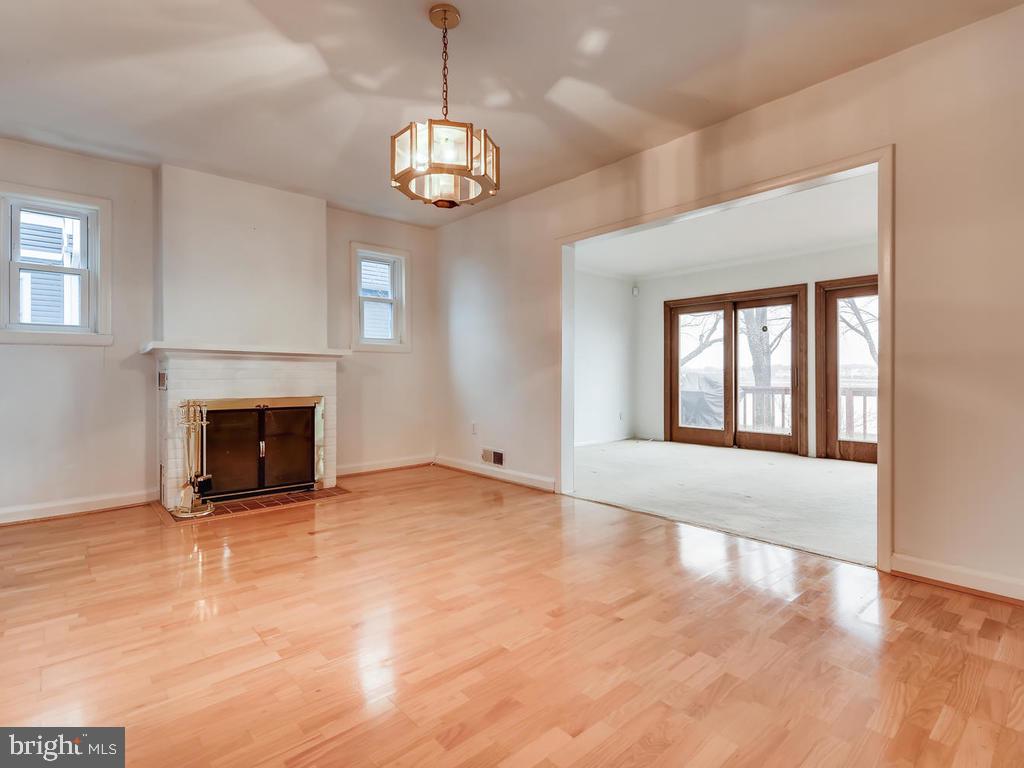 234 Harlem Road Pasadena, MD 21122 - Photo 7 of 30 Dining Room with Fireplace and Hardwood Flooring