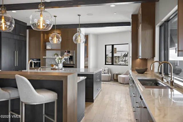 an empty room with a windows and chandelier