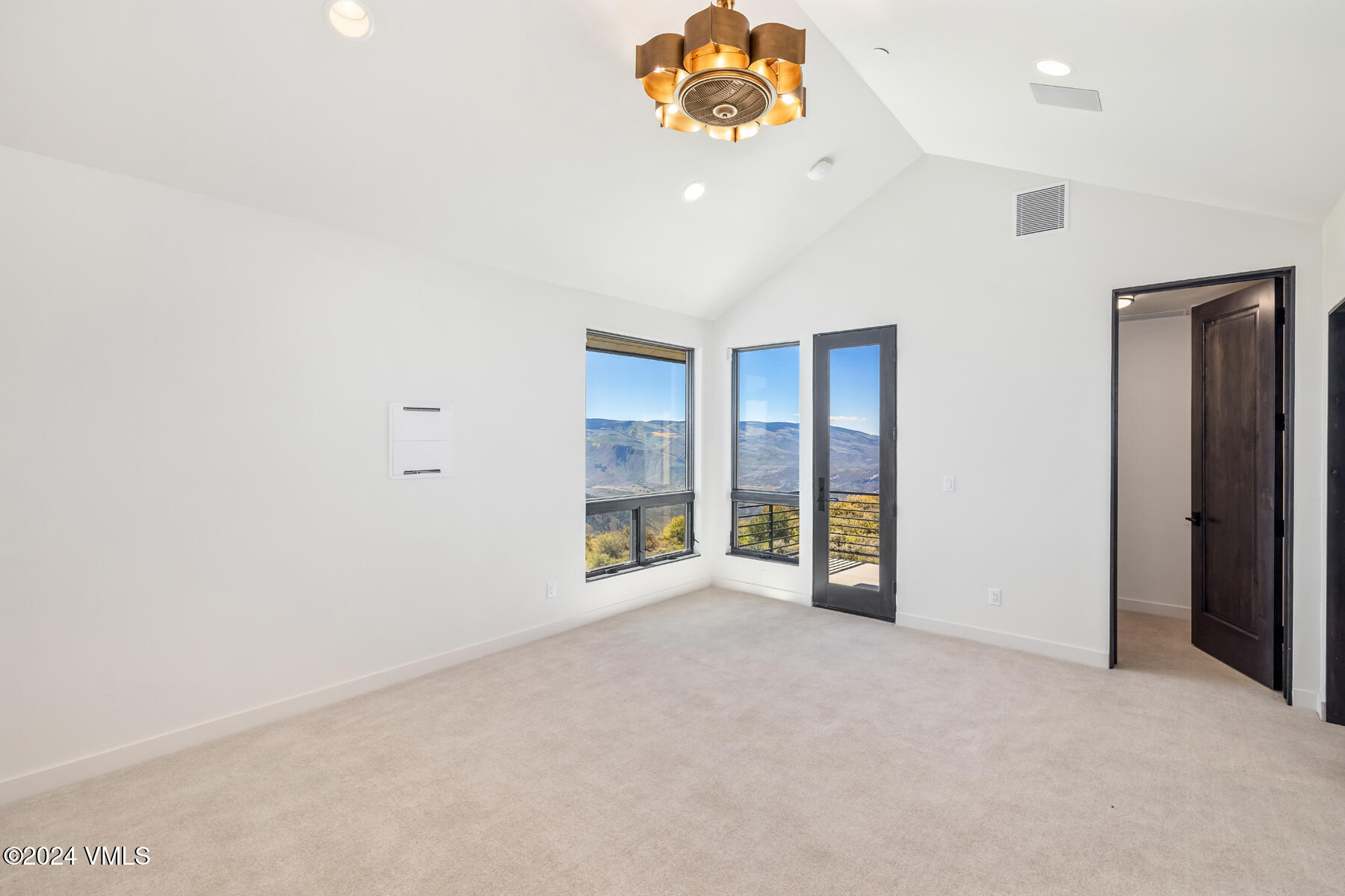 966 Webb Peak Edwards, CO 81632 - Photo 49 of 70 an empty room with a windows and chandelier