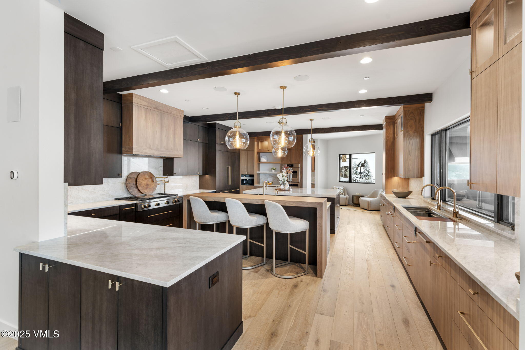966 Webb Peak Edwards, CO 81632 - Photo 9 of 70 a large dining hall with stainless steel appliances kitchen island granite countertop a large kitchen island a stove a sink a dining table and chairs with wooden floor