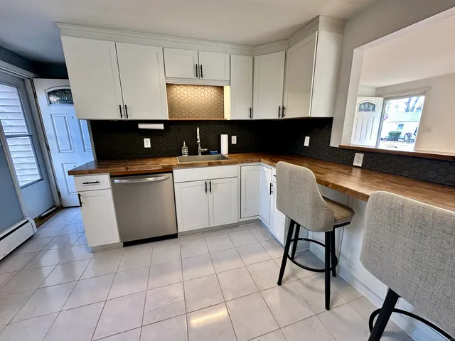 a view of a room with wooden floor and window