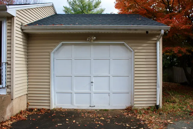 a kitchen with stainless steel appliances granite countertop a sink a stove a refrigerator a microwave a dining table and chairs with wooden floors