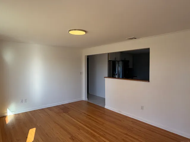 a view of an empty room and a window