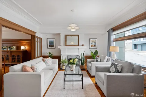 a living room with furniture and a chandelier