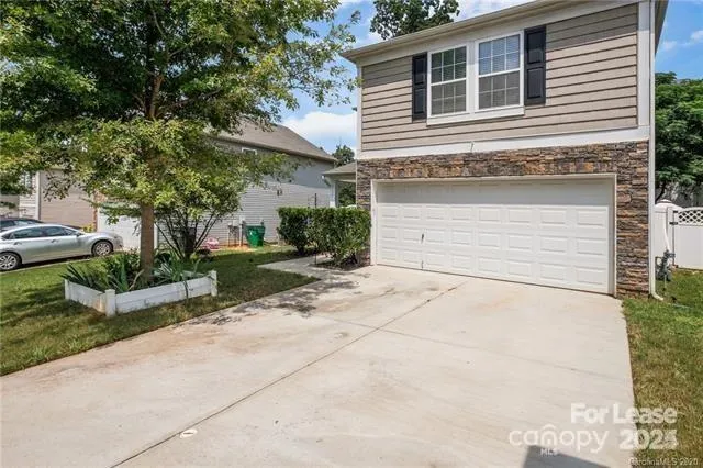 a view of a house with a yard and plants
