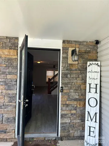 a view of staircase with wooden floor and fan