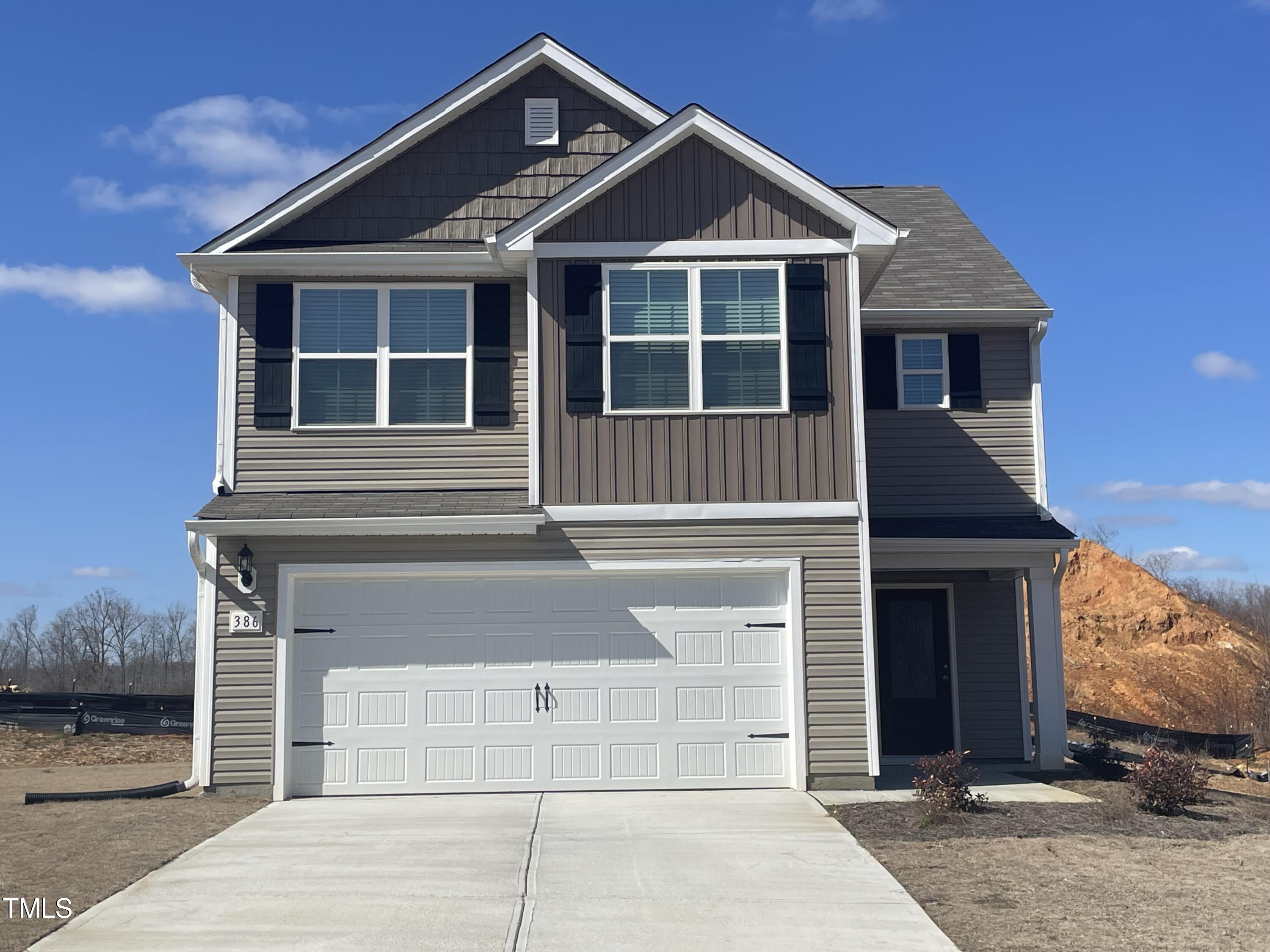 386 Crow Field Street Roxboro, NC 27574 - Photo 1 of 18 a front view of a house with a yard and garage