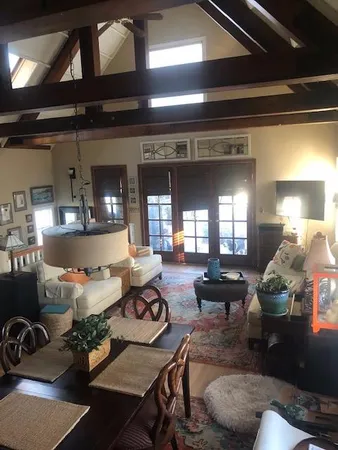 a living room with furniture and a chandelier