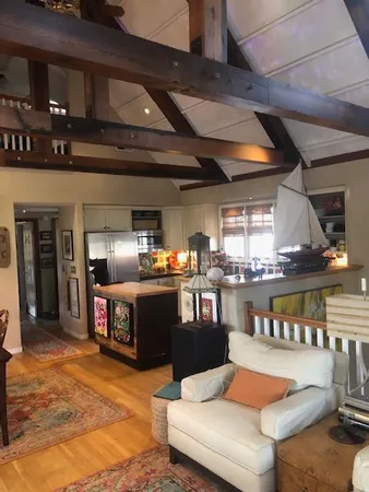 a living room with stainless steel appliances kitchen island granite countertop lots of furniture and a kitchen view