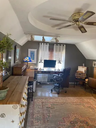 a living room with furniture and a gym machine
