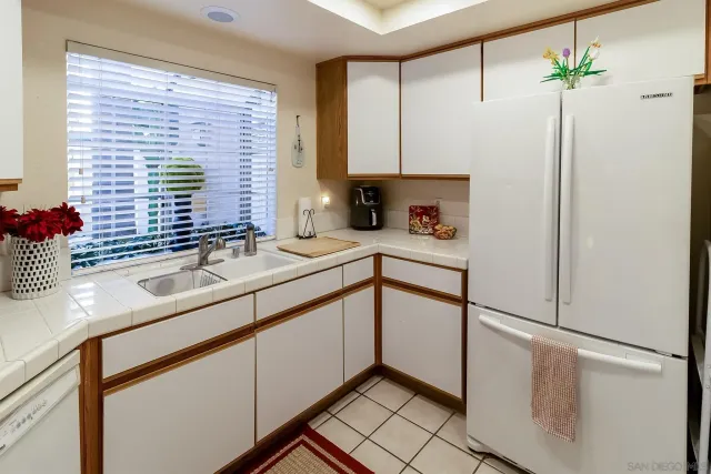 a kitchen with stainless steel appliances a sink and a refrigerator
