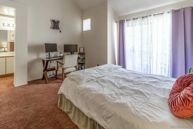 a bedroom with a bed and a table in it