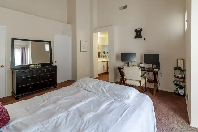 a bedroom with a bed and a television